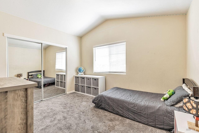 carpeted bedroom featuring a closet and lofted ceiling