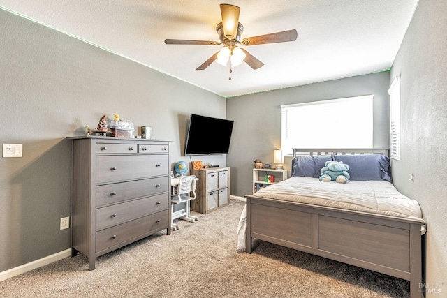 bedroom with baseboards, light carpet, and a ceiling fan