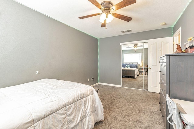 carpeted bedroom featuring visible vents, baseboards, and ceiling fan