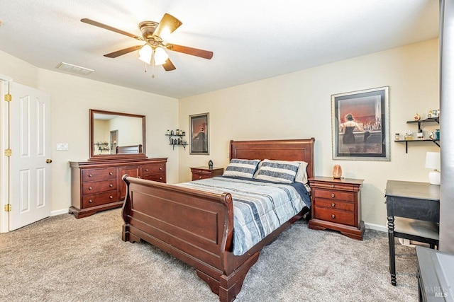 bedroom with baseboards, light carpet, a ceiling fan, and visible vents