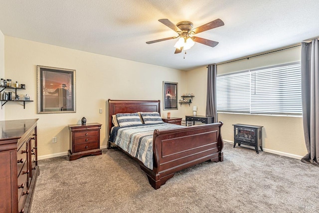 bedroom with baseboards, carpet, a ceiling fan, and a textured ceiling