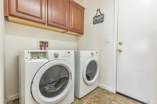 laundry room with baseboards, cabinet space, and washing machine and clothes dryer