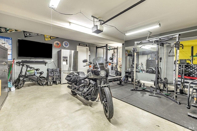 gym featuring secured water heater and a garage