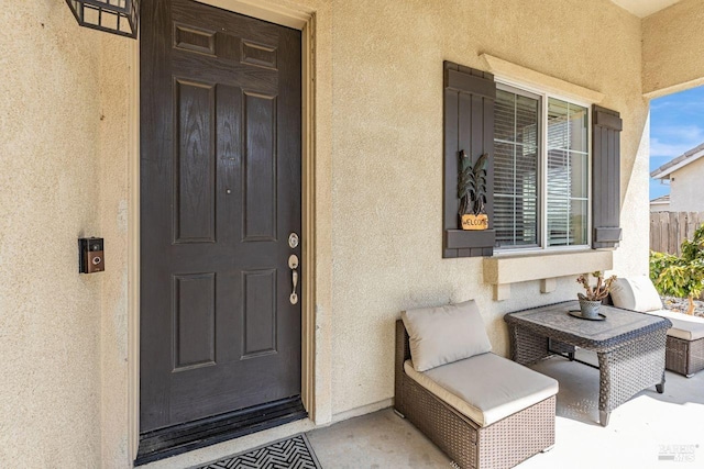 entrance to property with stucco siding