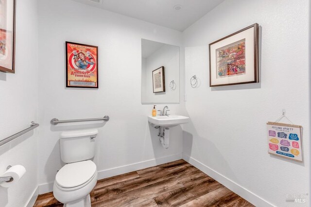 218 Johnson St, Windsor, CA 95492 - half bathroom with toilet, wood finished floors, baseboards, and a sink