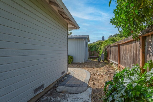 view of side of property featuring fence