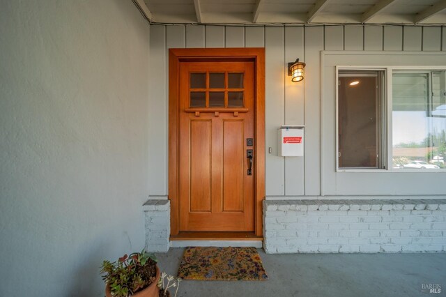 view of exterior entry featuring board and batten siding