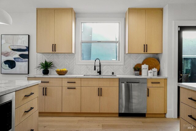 kitchen with light wood-type flooring, a sink, dishwasher, and light brown cabinets