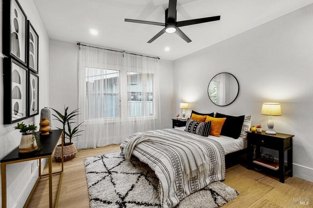 bedroom with light wood-type flooring, recessed lighting, baseboards, and ceiling fan