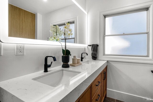 bathroom featuring double vanity and a sink