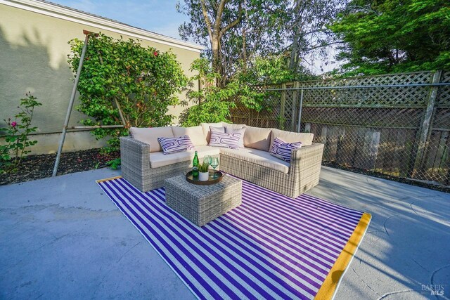 view of patio featuring fence and outdoor lounge area