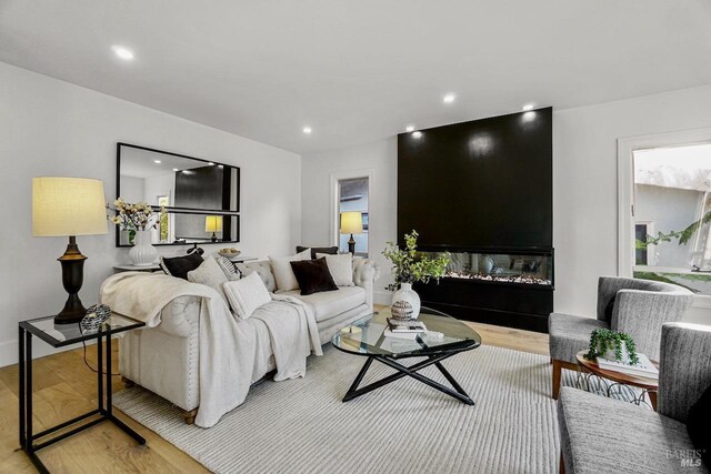 living room featuring light wood-type flooring and recessed lighting
