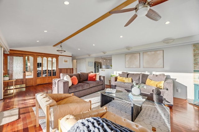 living room featuring wood finished floors, ceiling fan, recessed lighting, a wainscoted wall, and lofted ceiling with beams