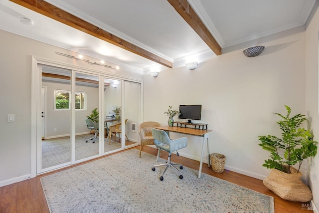 office space featuring baseboards, ornamental molding, and wood finished floors