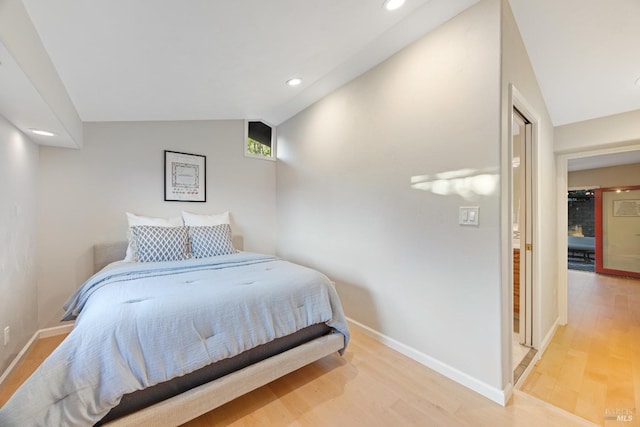 bedroom featuring light wood-style floors, recessed lighting, baseboards, and lofted ceiling