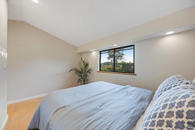 bedroom featuring recessed lighting, baseboards, wood finished floors, and lofted ceiling