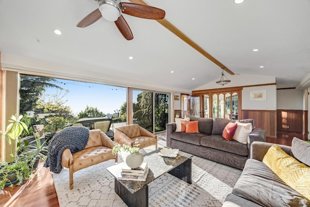 living room featuring a healthy amount of sunlight, lofted ceiling with beams, recessed lighting, and wood finished floors