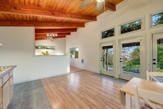 entryway with a ceiling fan, wood ceiling, high vaulted ceiling, and beamed ceiling