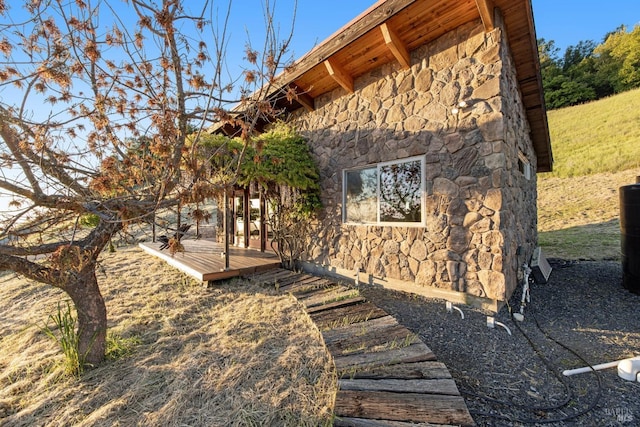 view of side of property with stone siding