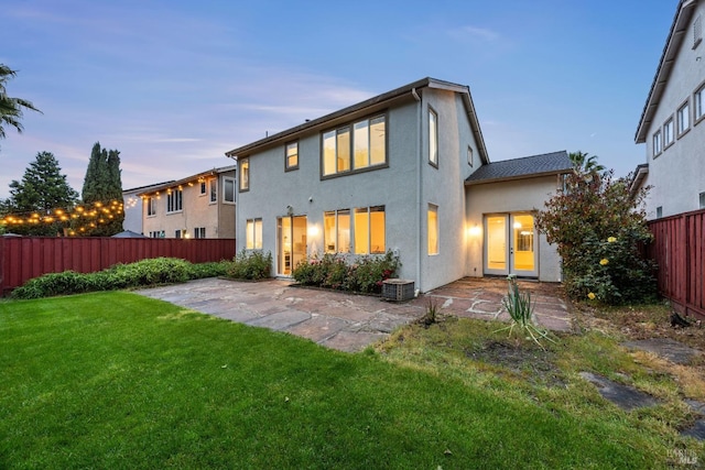 2916 Park Meadow Dr, Santa Rosa, CA 95407 - back of property at dusk with a lawn, a patio area, cooling unit, a fenced backyard, and stucco siding