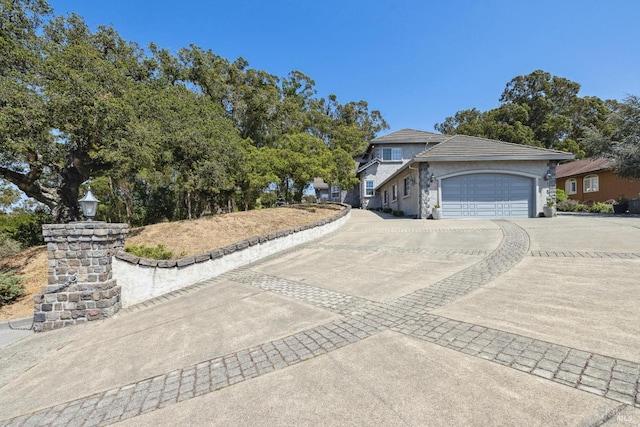 9 Canyon Ct, Petaluma, CA 94952 - view of front of home with a garage, stucco siding, and driveway