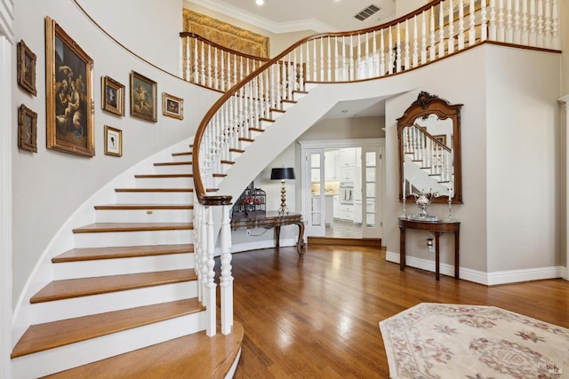9 Canyon Ct, Petaluma, CA 94952 - staircase with crown molding, baseboards, wood finished floors, a towering ceiling, and visible vents