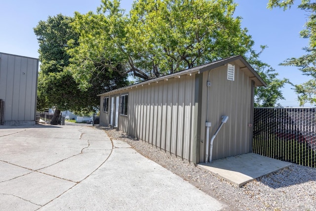 view of outbuilding with fence and an outdoor structure