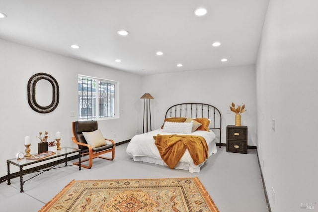 bedroom featuring recessed lighting and concrete floors