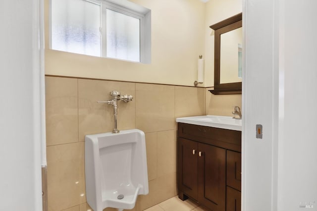 half bathroom with vanity, toilet, and tile walls