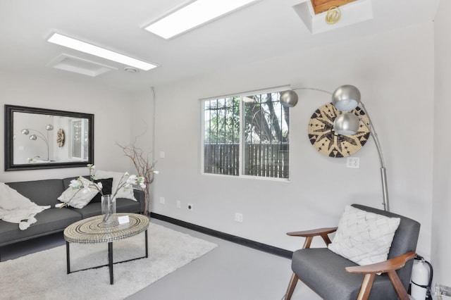 living room featuring baseboards and concrete floors