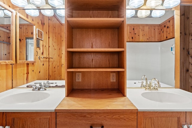 bathroom featuring wooden walls, vanity, and wood finished floors