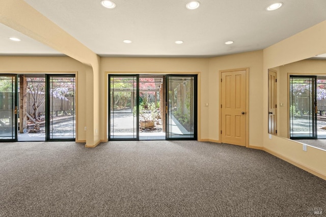 unfurnished living room featuring baseboards, recessed lighting, and carpet