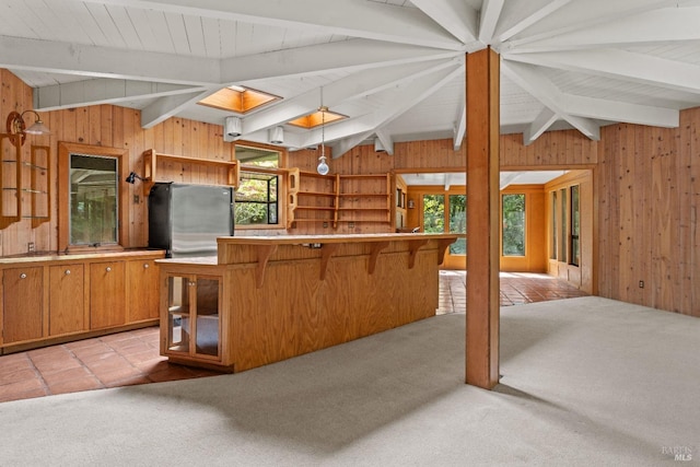kitchen with wooden walls and light carpet