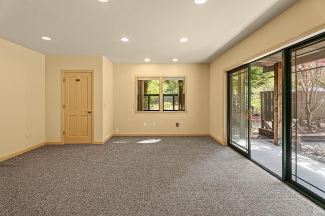 empty room featuring recessed lighting, baseboards, and carpet
