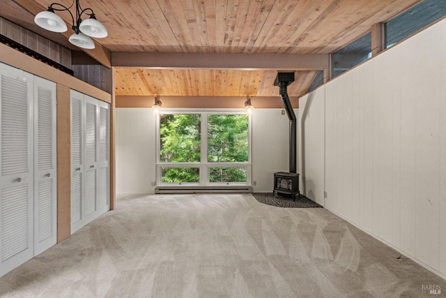 interior space featuring baseboard heating, wood ceiling, and carpet