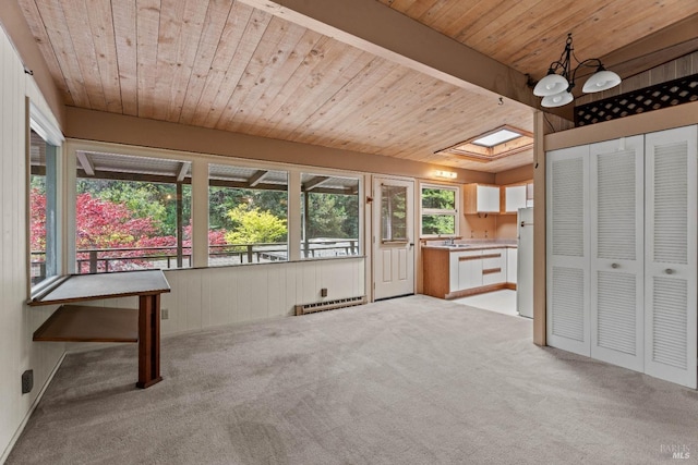 unfurnished sunroom featuring a sink and a skylight