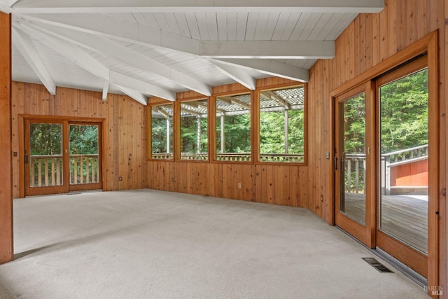 unfurnished sunroom featuring visible vents and beam ceiling