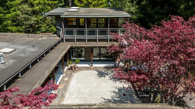 view of front of property with a patio and a balcony