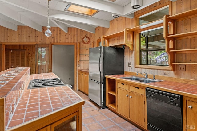 kitchen featuring open shelves, appliances with stainless steel finishes, a sink, plenty of natural light, and tile countertops