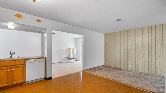 interior space featuring visible vents, a sink, light wood-style flooring, and dishwasher