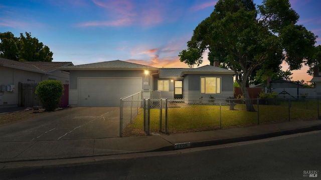 ranch-style home with a fenced front yard, an attached garage, concrete driveway, and a front lawn