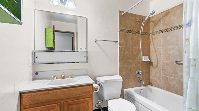 full bathroom featuring vanity, shower / bath combo with shower curtain, and toilet