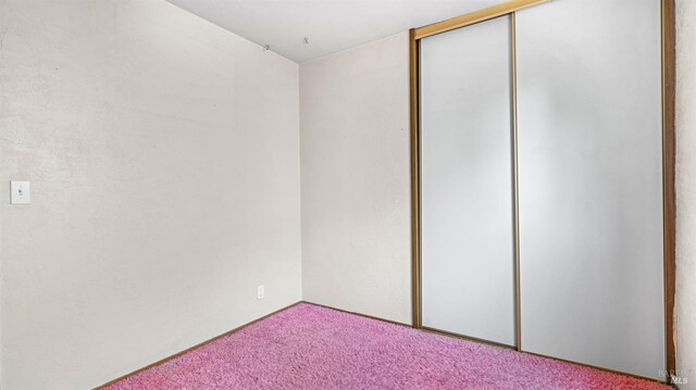 spare room featuring light carpet