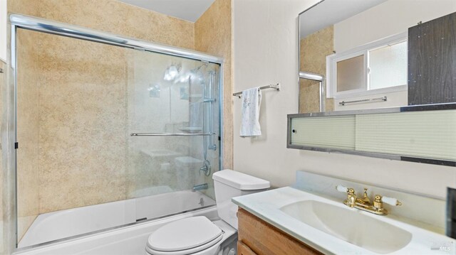 full bathroom with toilet, shower / bath combination with glass door, and vanity