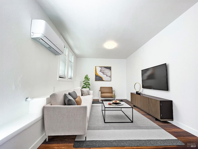 living area featuring baseboards, a wall unit AC, and dark wood-type flooring
