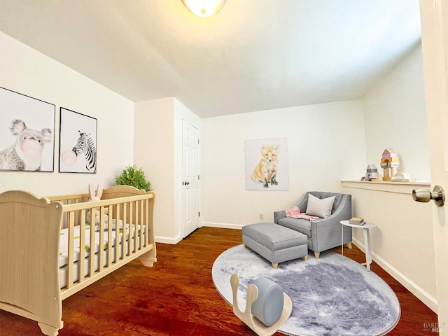 bedroom with baseboards and wood finished floors