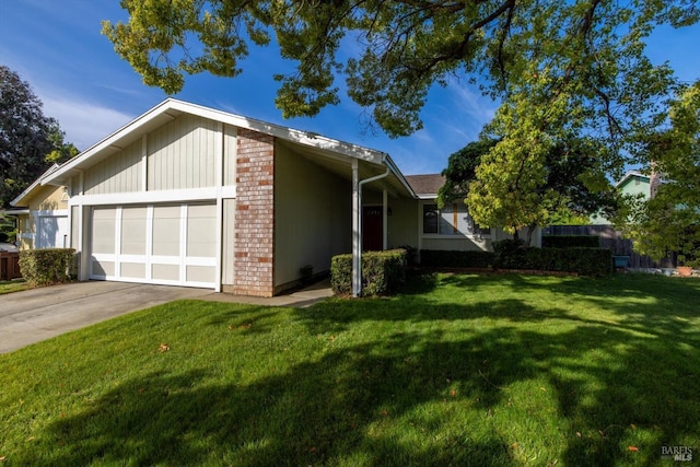 view of property exterior featuring a lawn, brick siding, an attached garage, and driveway