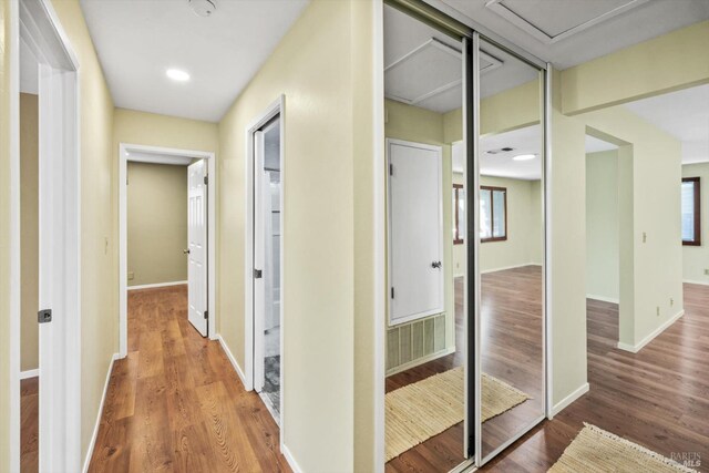 corridor featuring recessed lighting, baseboards, visible vents, and wood finished floors