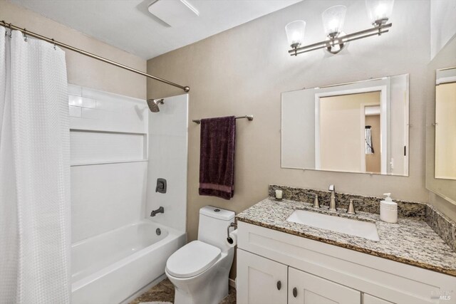bathroom featuring toilet, shower / bath combination with curtain, and vanity