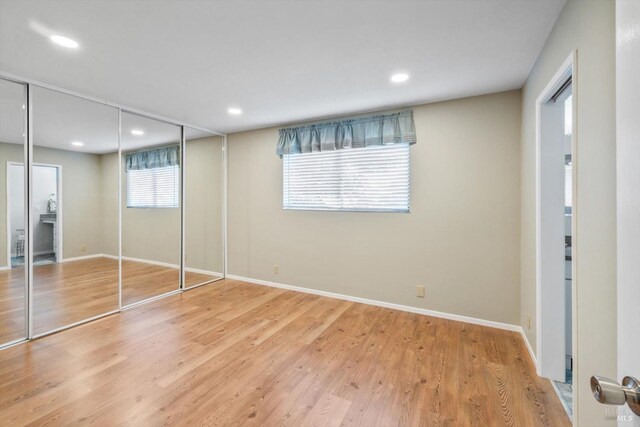 unfurnished bedroom featuring recessed lighting, baseboards, and light wood-type flooring